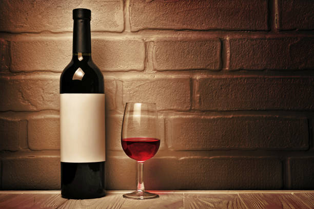 istock Red wine bottle with empty label and glass for tasting 983576846