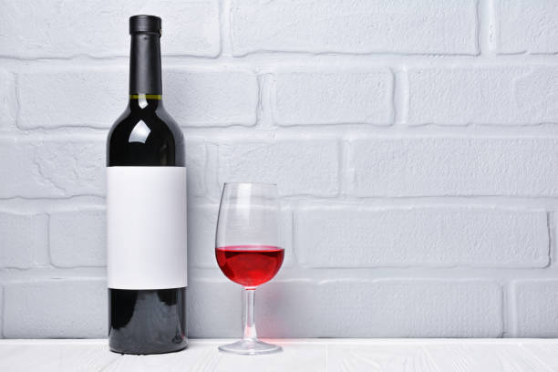 istock Red wine bottle with empty label and glass for tasting 983576862