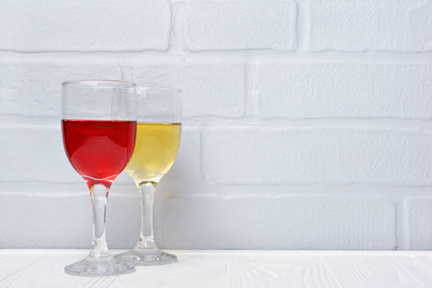 istock Couple glasses with red and white wine for tasting 983576898