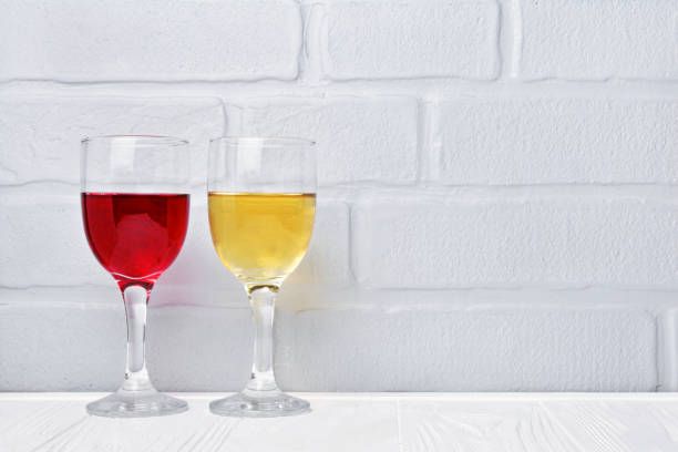 istock Couple glasses with red and white wine for tasting 983576938