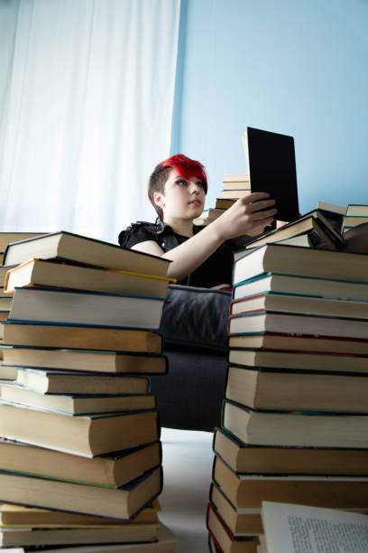 istock Young lady with dyed hair studying 983588814