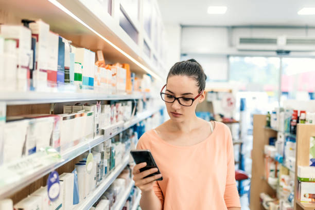 istock Woman using smart phone in supermarket 983596286