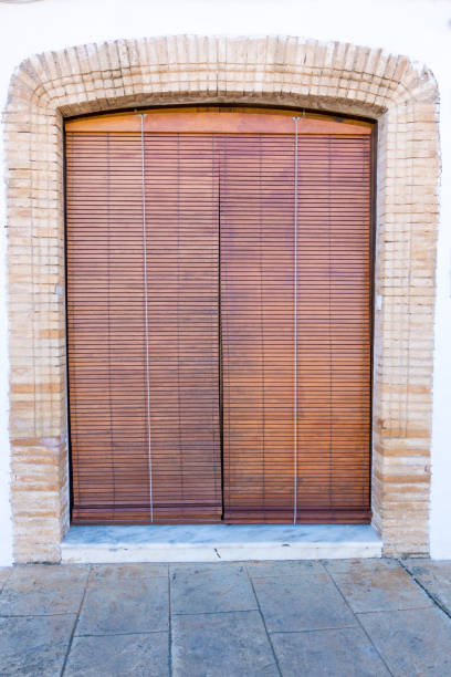 istock Closed door covered with wooden blinds 983601072
