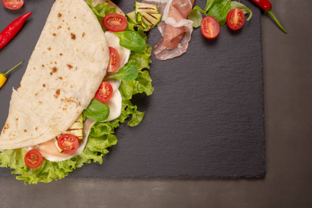 istock Piadina romagnola with cheese and ham 983601130