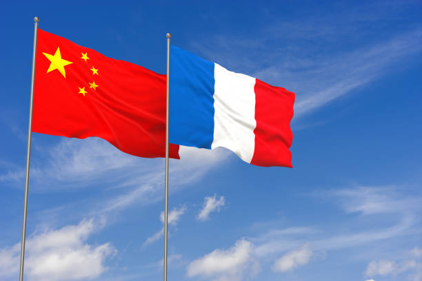 China and France flags over blue sky background. 3D illustration stock photo