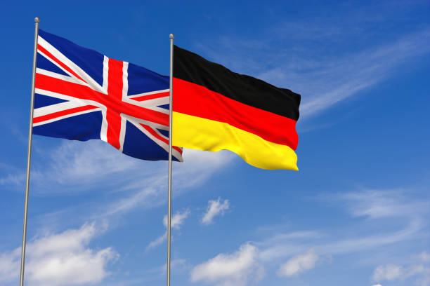 istock United Kingdom and Germany flags over blue sky background. 3D illustration 983636610