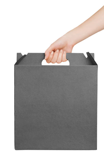 istock Female hand holding a black cardboard box 983648094
