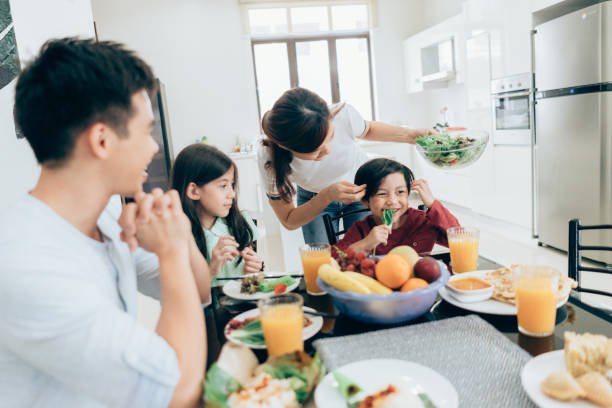 istock Smiling Modern mom serving a healthy meal 983652614