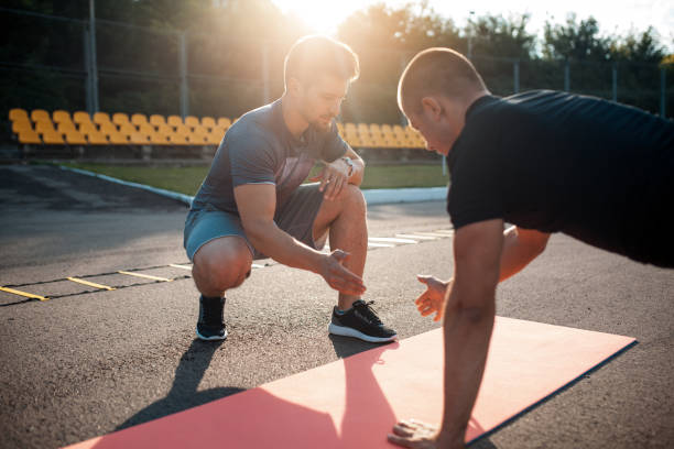 istock morning exercises with personal coach; 983656056