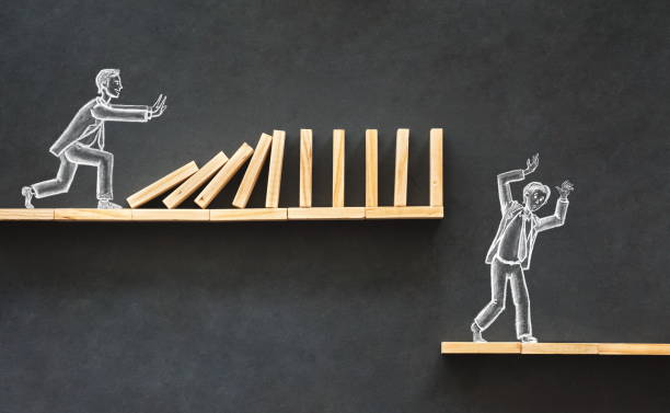 istock Domino Effect and Business Challenge Concept with Hand Drawn Chalk Illustrations on Blackboard 983668758