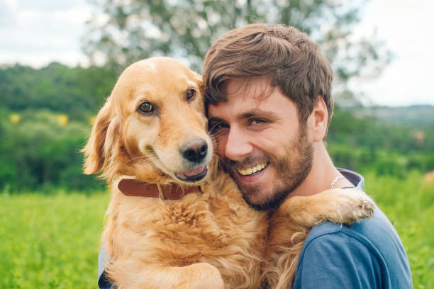 istock Guy and his dog, golden retriever, nature 983672318