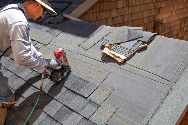 Installing new roof with nail gun stock photo