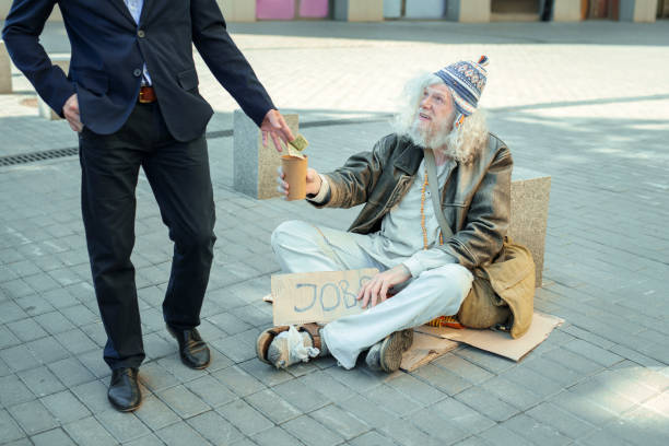 istock Homeless non-conformist begging for job 983672444