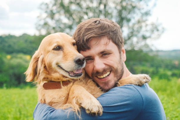 istock Guy and his dog, golden retriever, nature 983675278