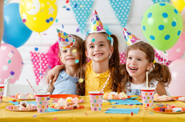 istock children's birthday. happy kids with cake 983675794