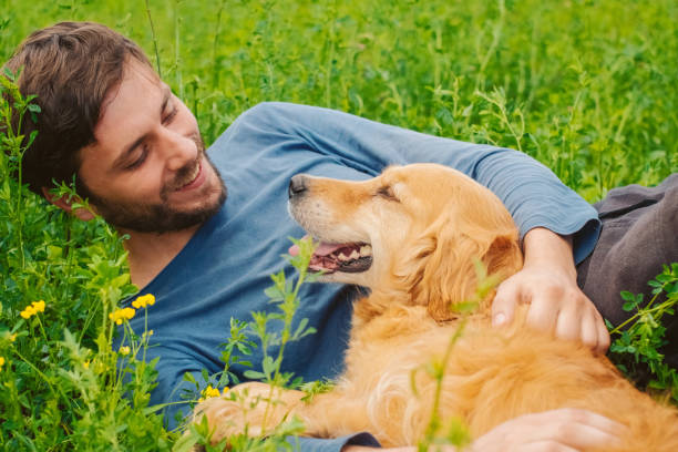 istock Guy and his dog, golden retriever, nature 983675884