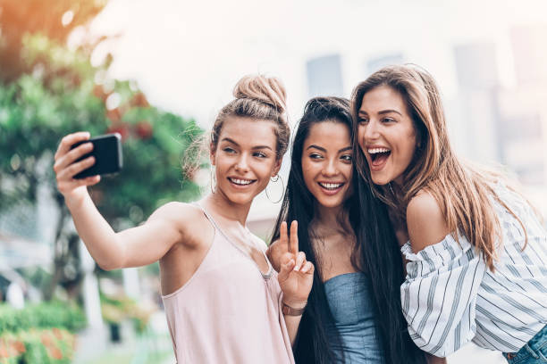 istock Group of girls making selfie 983676192