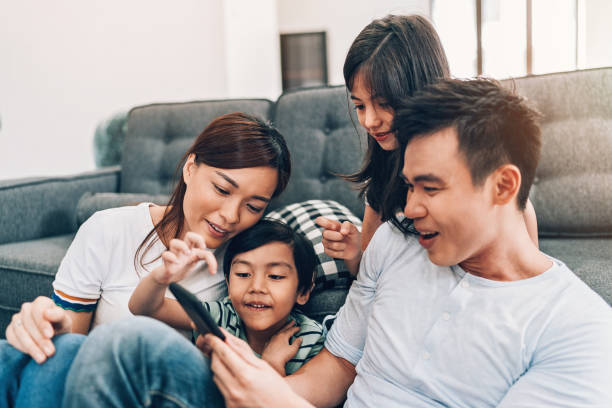 istock Young family texting at home 983676216