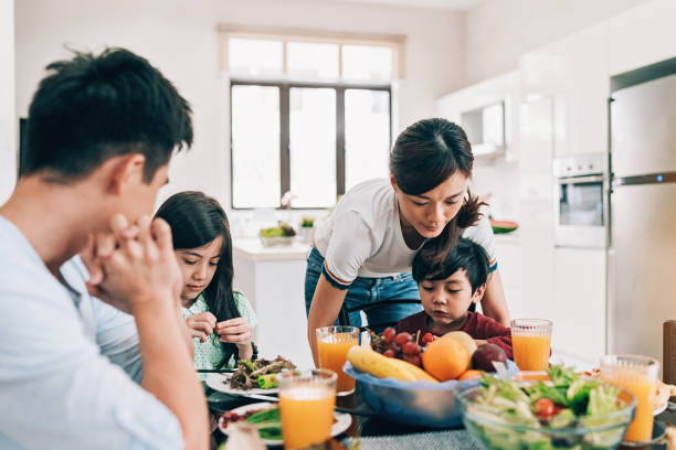 istock Family in the dining room eating together 983676232