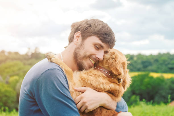 istock Guy and his dog, golden retriever, nature 983676504