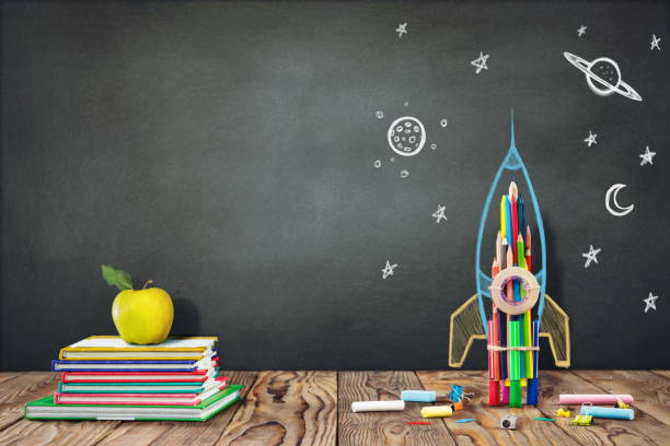 istock Back to School Concept with Hand Drawn Rocket on Blackboard 983692800
