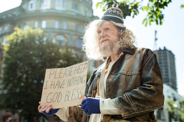 istock Homeless street man asking people for any help 983697086