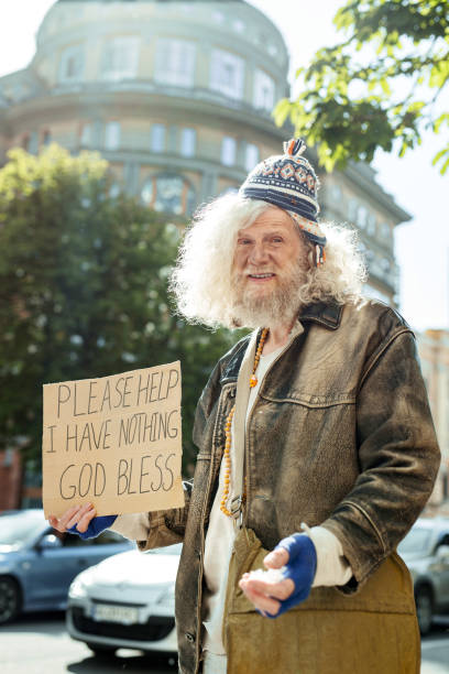 istock Homeless wearing old brown leather jacket 983699544