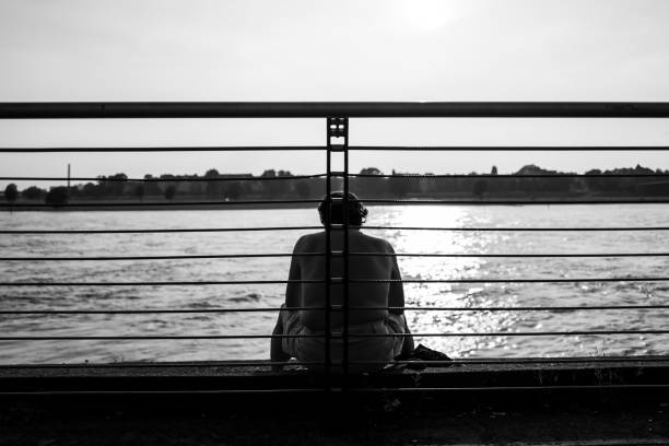 istock Man sitting at the Rhine in Duesseldorf, Germany 983703506