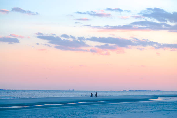 istock Silhouette of Two Bikers on the Beach 983705956