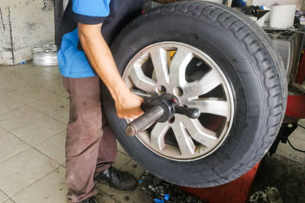 istock Series of technician performing car wheel tire balancing 983705980