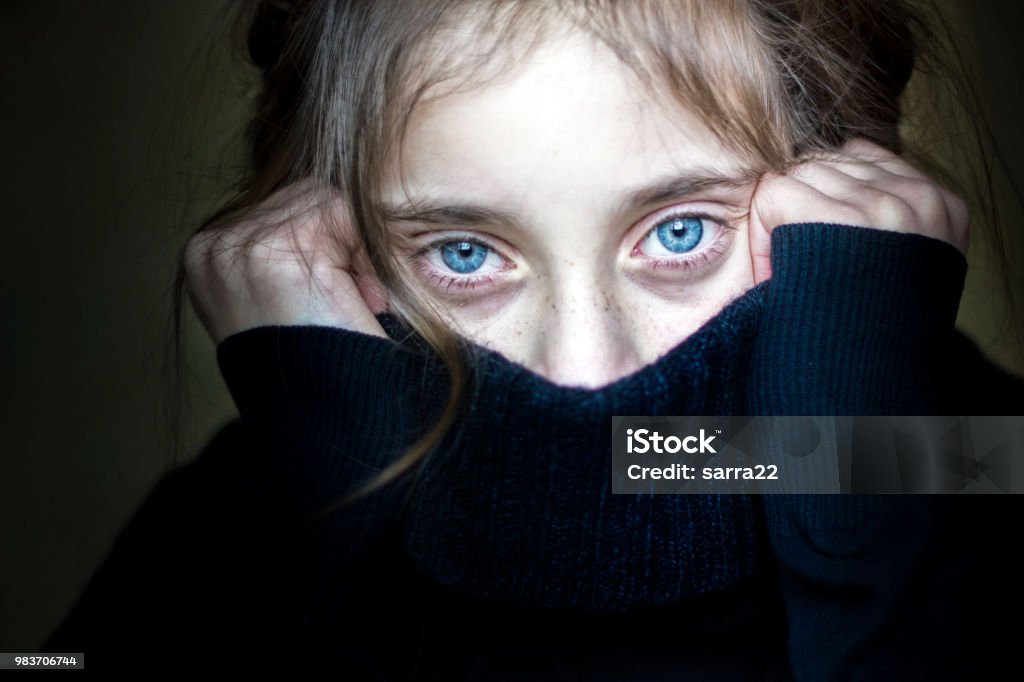 Girl hiding her face. Worried and scared girl hiding her face Child Stock Photo