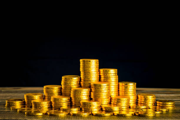 istock large amount of gold coins with black back 983734788