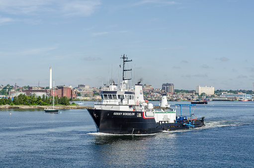New Bedford, Massachusetts, USA - June 22, 2018: Supply ship Gerry Bordelon, hailing port New Orleans, Louisiana, passing Palmer Island Light Station in New Bedford
