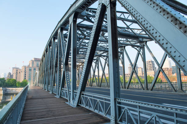 istock Iron bridge wooden sidewalk. 983749362