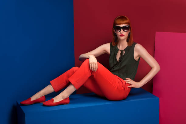 istock Fashionable redhead woman posing in studio. 983749380