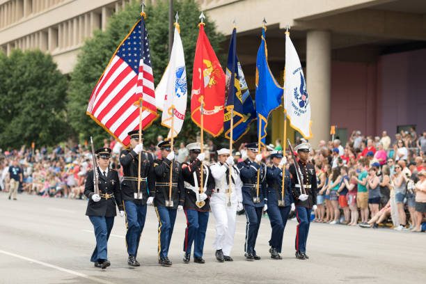 Indy 500 Parade 2018 Indianapolis, Indiana, USA - May 26, 2018, Members of the USA Military carry the American flag at Indy 500 Parade parade stock pictures, royalty-free photos & images