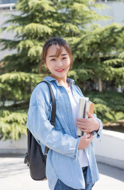 istock Female college student with backpack at university. 983759334