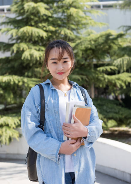 istock Female college student with backpack at university. 983759356