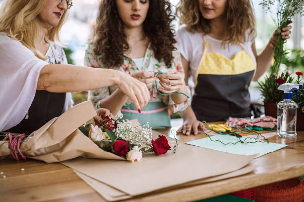 istock Daughters Helping their Mother Decorating Bouquet 983762470