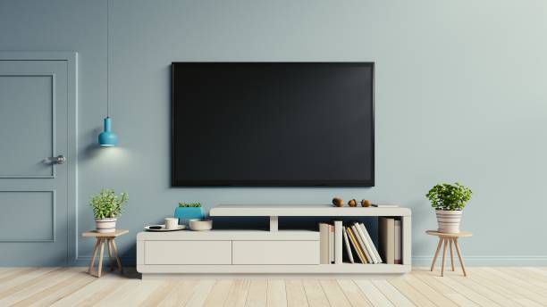 istock Smart Tv cabinet in modern empty dark room, 983793596