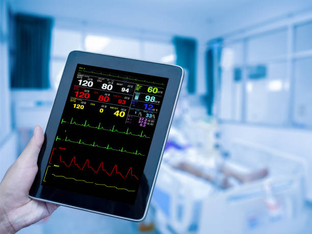 istock doctor's hand holding the tablet displaying ECG in the intensive care unit (ICU). process in blue tone. 983794742