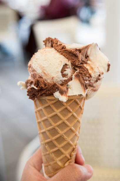 istock Hand holding Chocolate Gelato, Ice-cream with blur background. 983800832