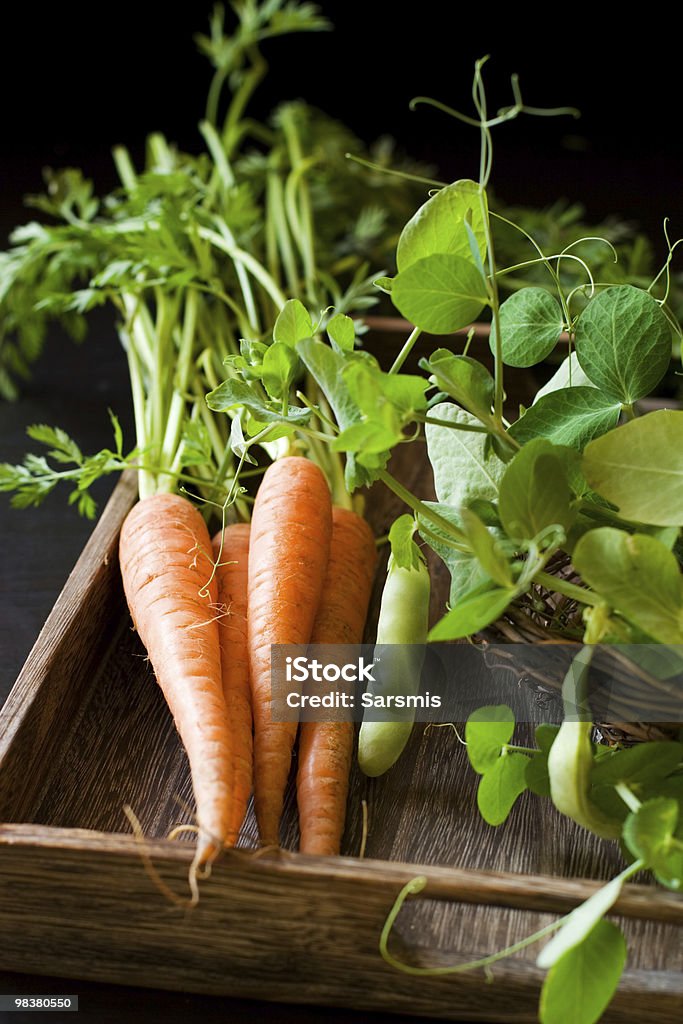 fresh carrots and green pea fresh organic carrots and green pea Basket Stock Photo