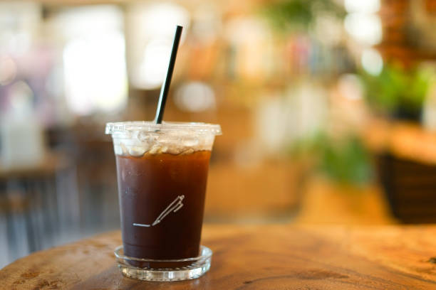 istock close up Iced americano with blur interior cafe background 983846302