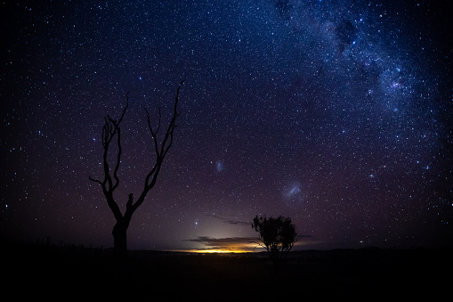 The milky way extends into the sky as seen from a location in the southern hemisphere