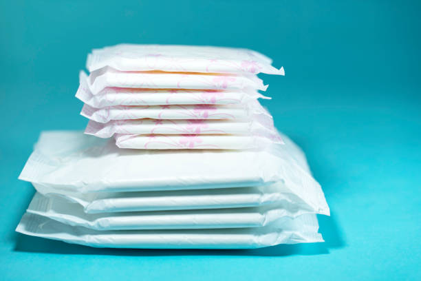 Sanitary pads and absorbent sheets on blue background stock photo
