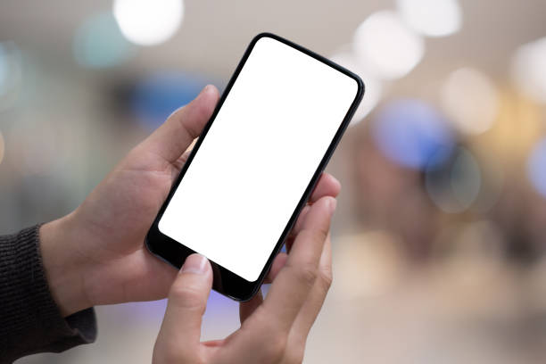 istock Technology, Communication and People concept - close up of man hands with smartphone texting message on city street blurred background. blank screen for graphics display montage. 983889398