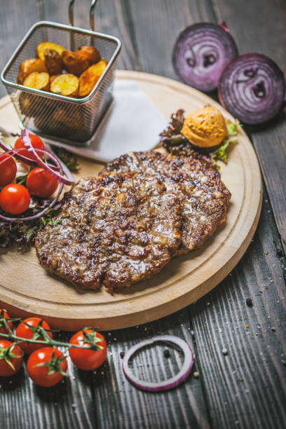 istock hamburger steak with baked potatoes and vegetables 983889478