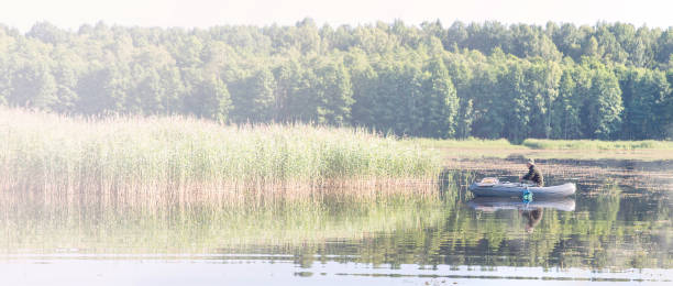 istock Man in Fishing Boat 983898564