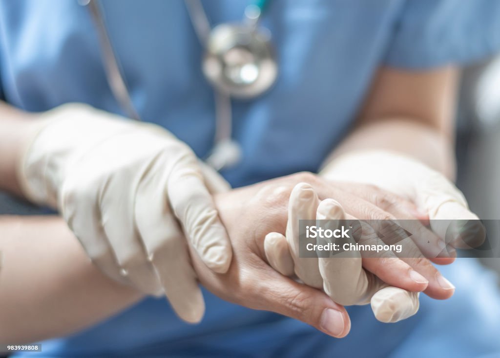 Surgeon, surgical doctor, anesthetist or anesthesiologist holding patient's hand for health care trust and support in professional surgical operation, medical anesthetic safety, healthcare concept Patient Stock Photo